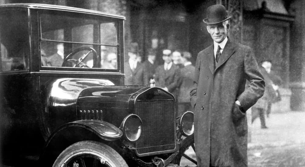 Henry Ford is standing next to a Model T in 1921, showing the pedigree of Ford dealerships everywhere.