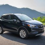 A black 2021 Buick Encore is parked with mountains in the background.