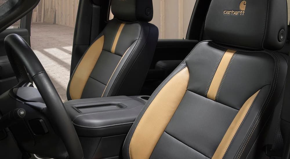 The black and tan seats are shown in a 2021 Chevy Silverado 2500 Carhartt Edition.