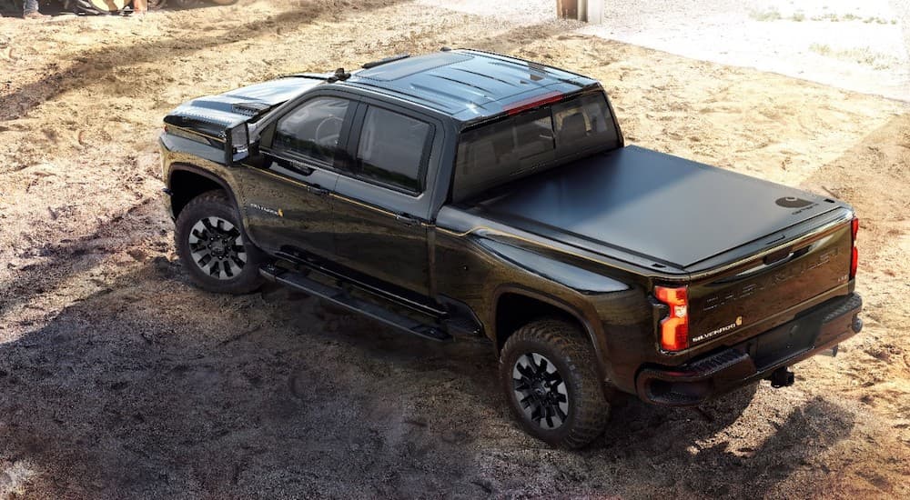 A black 2021 Chevy Silverado 2500 Carhartt Edition is shown from the rear at a higher angler.