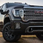 The front of a black 2021 GMC Sierra HD, one of the popular 2021 GMC diesel trucks, is shown from a low angle.