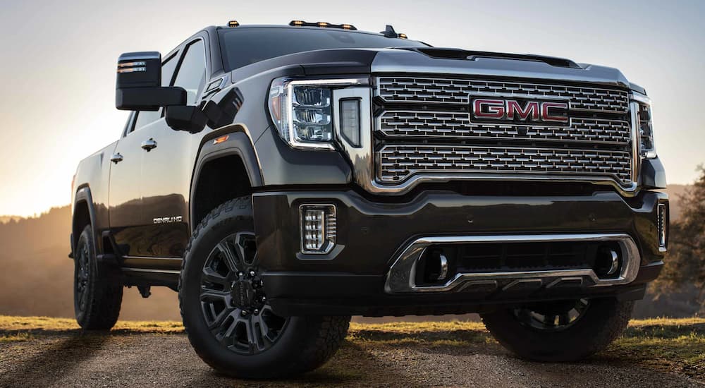 The front of a black 2021 GMC Sierra HD, one of the popular 2021 GMC diesel trucks, is shown from a low angle.
