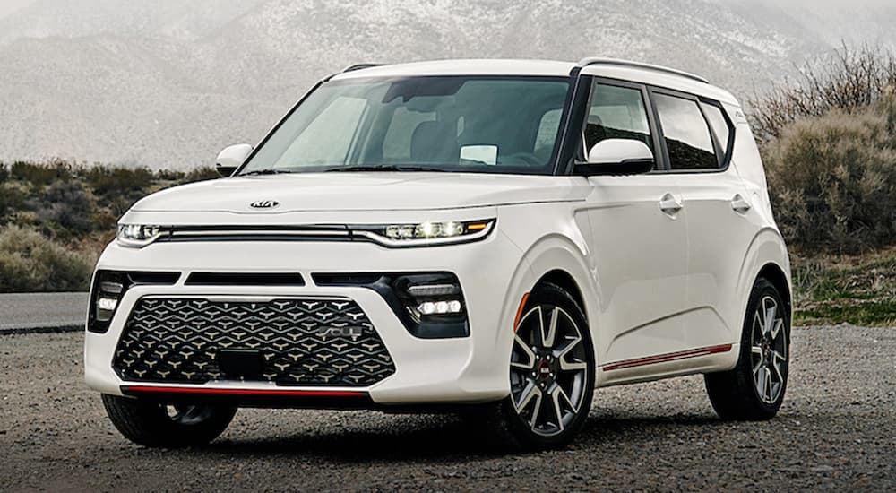 A white 2021 Kia Soul is parked in front of a foggy mountain after winning the 2021 Kia Soul vs 2021 Nissan Kicks comparison.
