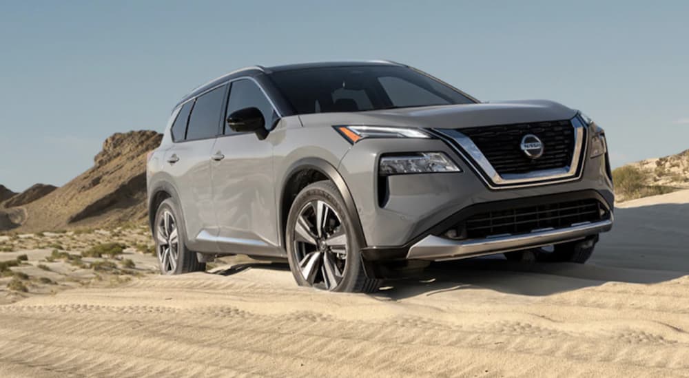 A grey 2021 Nissan Rogue is off-roading in sand.