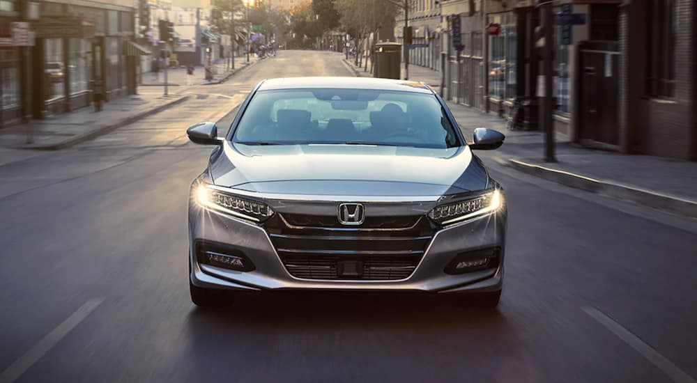 A silver 2020 Honda Accord from a Certified Honda dealer near me is shown from the front on a city street.