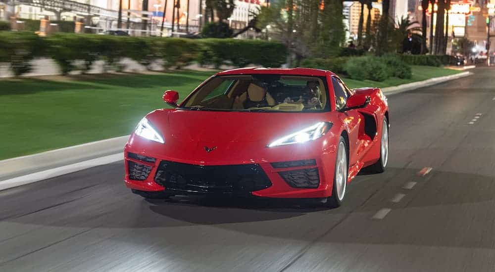 A red 2020 Chevy Corvette Stingray is driving through the city after leaving a Chevy dealer near you.