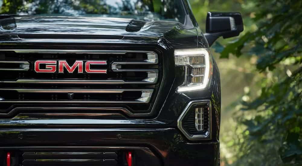 A close up of the black grille of a GMC truck is shown.