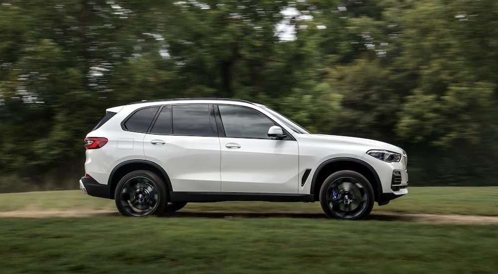 A white 2018 Used BMW X5 is shown from the side on a dirt path.
