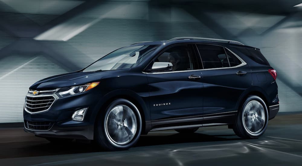 A dark blue 2020 Chevy Equinox is driving in a tunnel.
