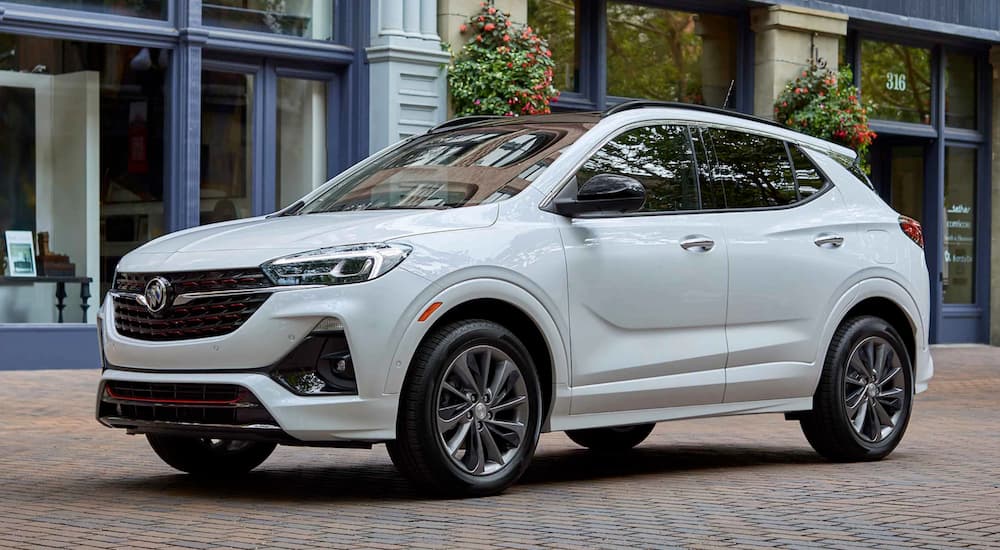 A white 2021 Buick Encore GX is parked on a city street after a 2021 Buick Encore vs 2021 Buick Encore GX comparison.