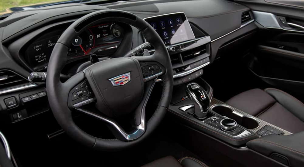 The wheel and dashboard in a 2021 Cadillac CT4 are shown.