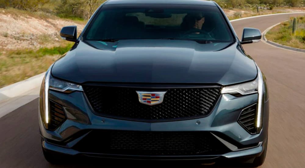 A grey 2021 Cadillac CT4 V is shown from the front on a rural road.