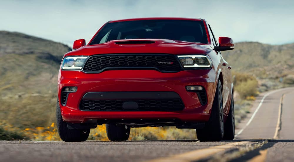 A red 2021 Dodge Durango is shown from the front on a rural road.