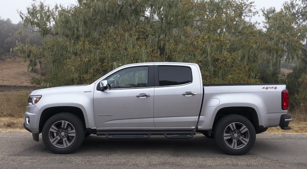 A popular Certified Pre-Owned Chevy truck, a silver 2018 Chevy Colorado is shown from the side.
