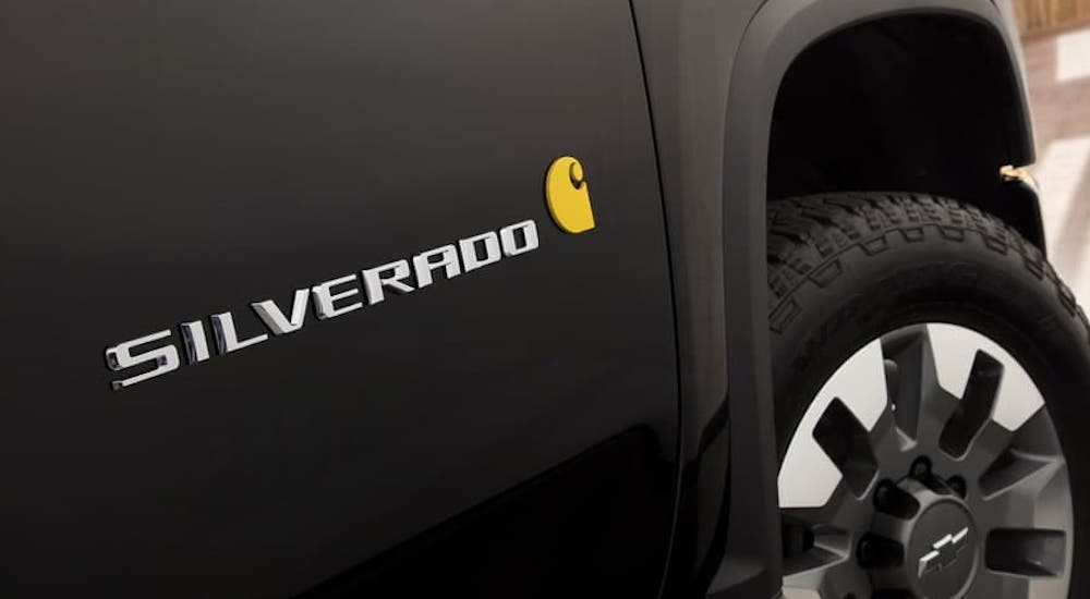 A closeup shows the badging on a black 2021 Chevy Silverado HD Carhartt edition, find one at your local Chevy diesel truck dealer.