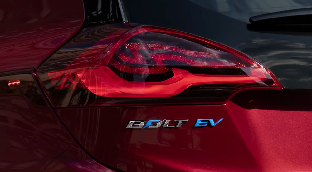 The badging on the back of red 2021 Chevy EV that says 'Bolt EV'.