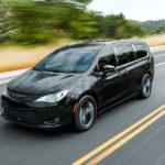 A black 2020 Chrysler Pacifica is driving on a highway after leaving a used Chrysler dealer.
