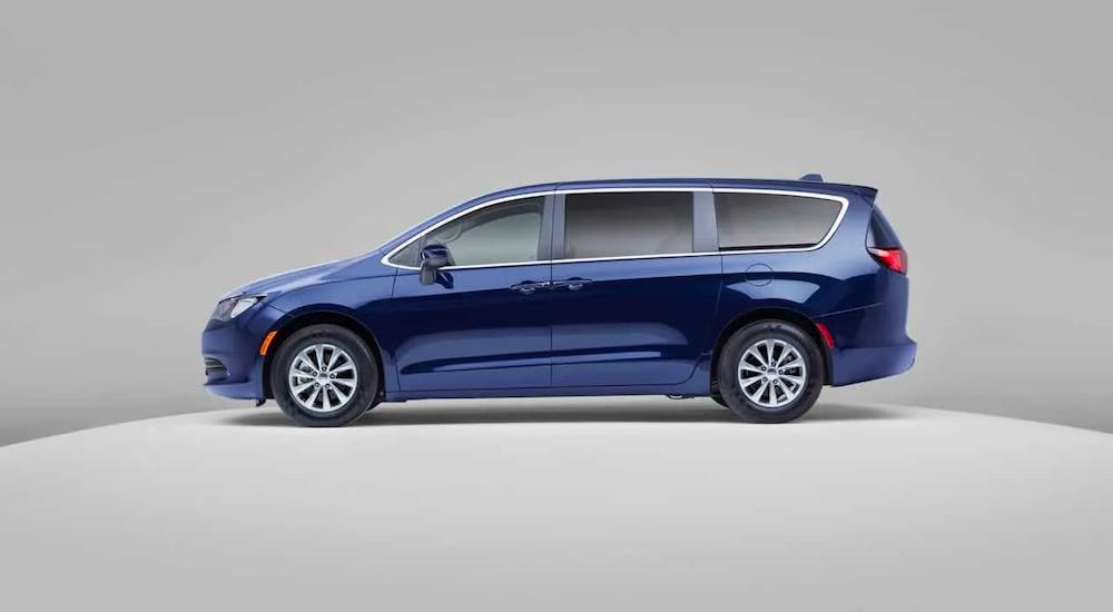 A blue 2020 Chrysler Voyager is shown from the side against a gray background.