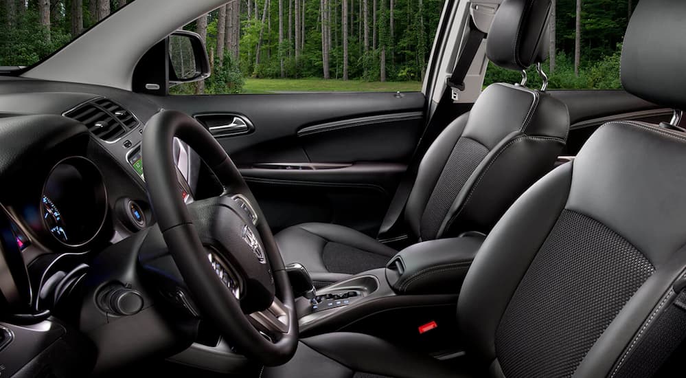 The black interior in a 2020 Dodge Journey is shown from the side.