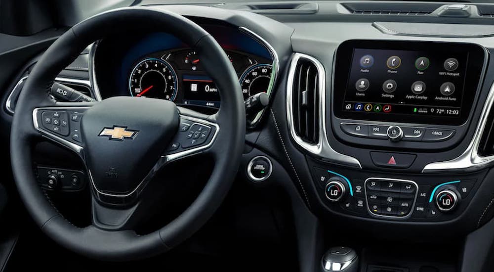 The wheel and screen in a 2021 Chevy Equinox is shown.