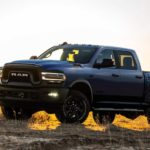 A blue 2021 Ram 2500 Power Wagon is in front of a sunset.