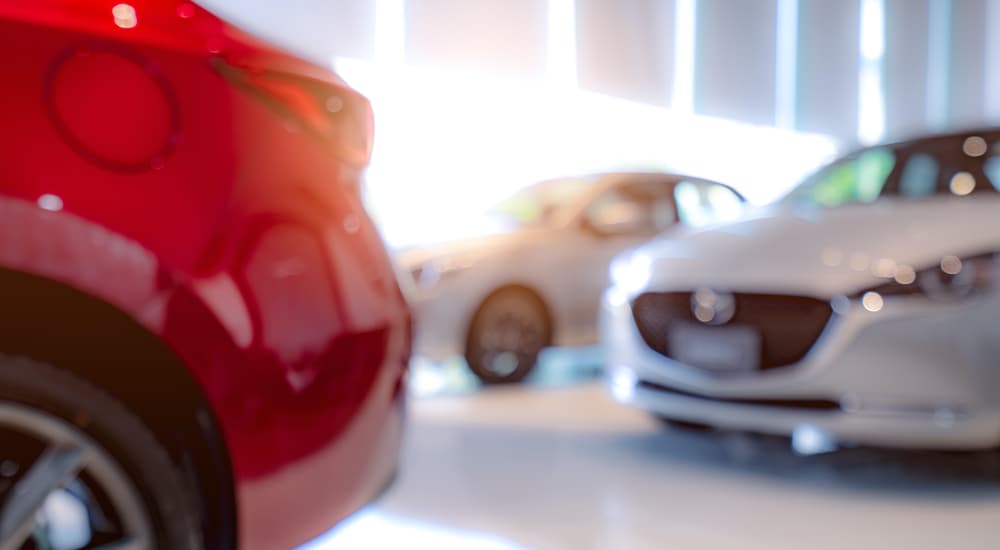 Multiple out of focus cars are shown from a low angle at a Seatonville Ford Dealership.