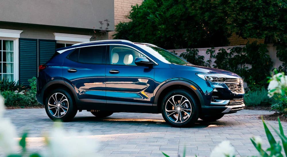 A dark blue 2021 Buick Encore GX is parked in a nice driveway.