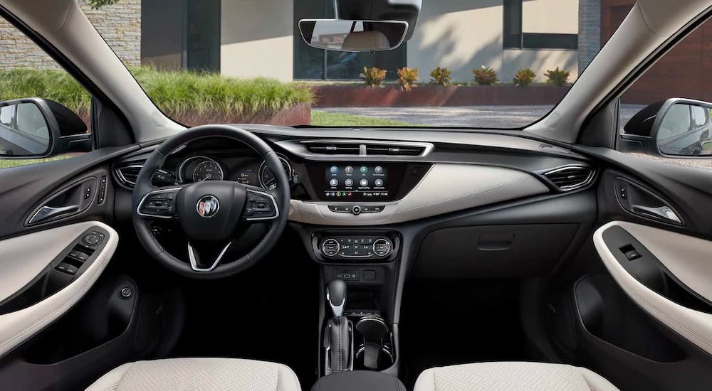 The black and gray dashboard and steering wheel are shown in a 2021 Buick Encore GX.