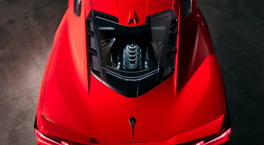 A close up shows the engine in a red 2021 Chevy Corvette from a high angle.