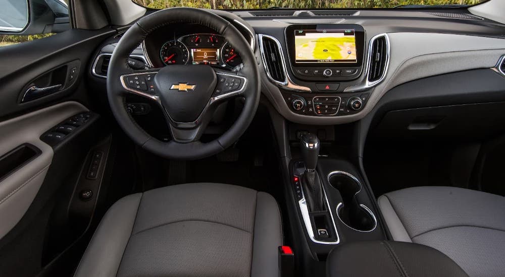 The black interior and dashboard of a 2021 Chevy Equinox are shown.