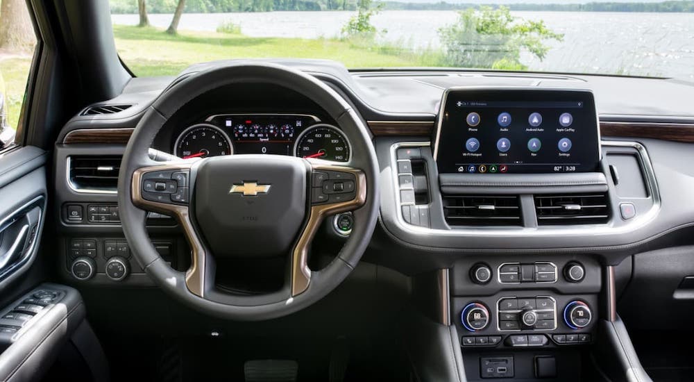 The steering wheel and dashboard of a 2021 Chevy Tahoe High Country is shown as part of the 2021 Chevy Tahoe vs 2021 Toyota Sequoia comparison.