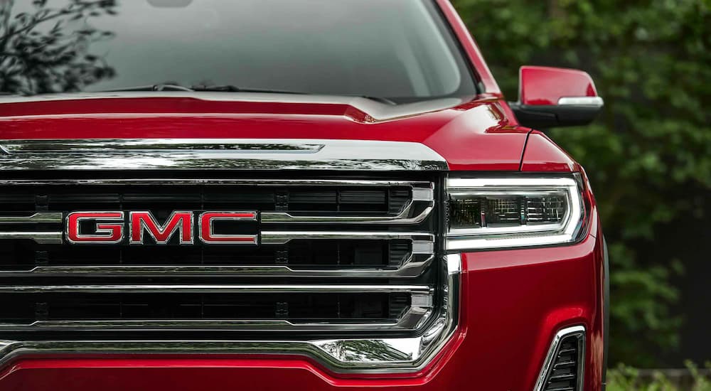 A close up shows the grille and headlight on a 2021 GMC Acadia.