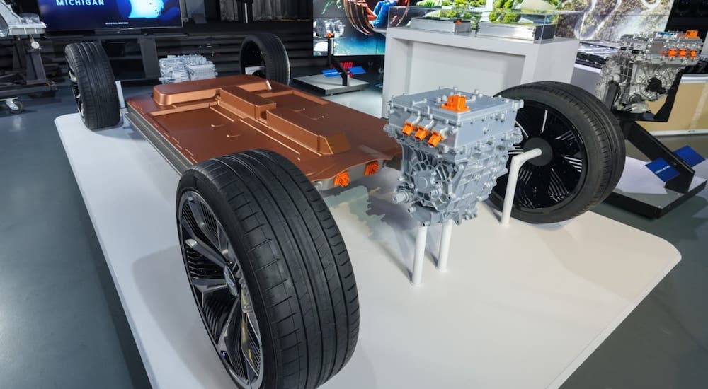 The Ultium battery and frame of an EV car is shown at an angle at a conference.