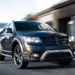 A grey 2020 Dodge Journey from a Dodge Journey dealer is driving on a city street.