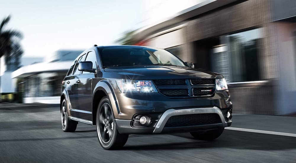 A grey 2020 Dodge Journey from a Dodge Journey dealer is driving on a city street.