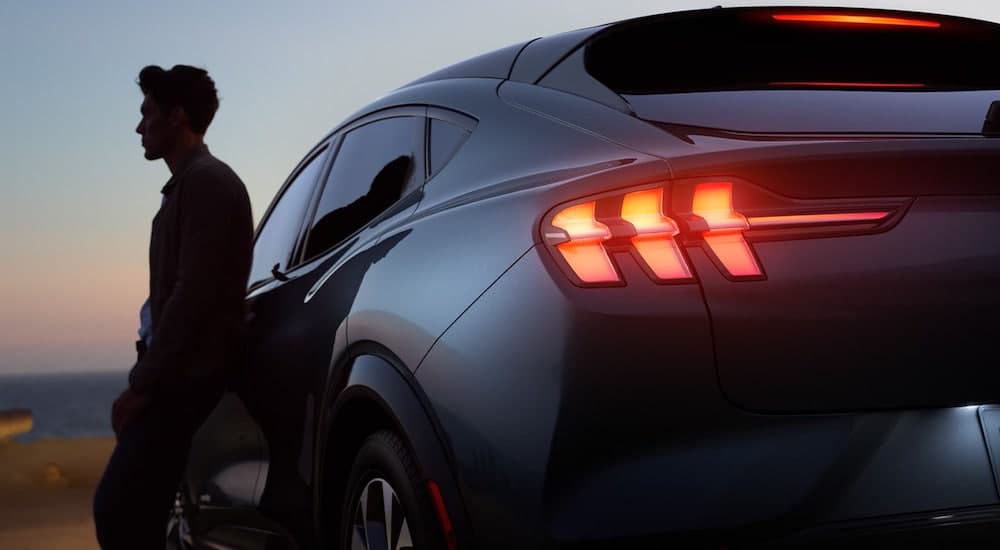 A close up shows a gray 2021 Ford Mustang Mach-E from behind after leaving a Ford dealer in Louisville.