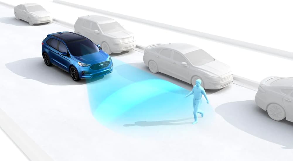 A blue SUV is shown with simulated pre-collision warning sensors on a person crossing the road.