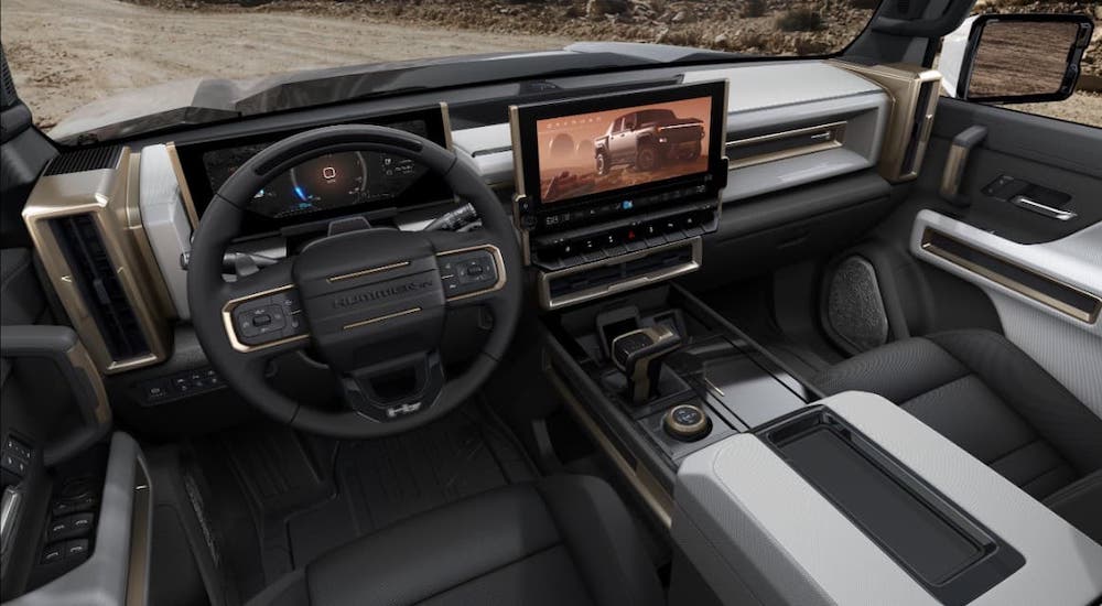 The black and gray interior and dashboard in a 2022 GMC Hummer EV are shown.