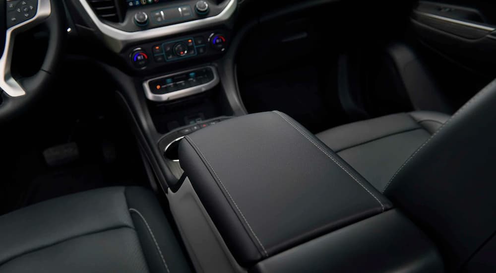 The black interior and center console is shown in a 2021 GMC Acadia SLT.
