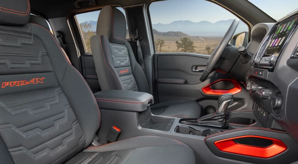 The gray and orange interior is shown in a 2022 Nissan Frontier Pro4x.