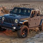 A grey 2021 Jeep Gladiator is off-roading in the desert.