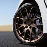 The bronze wheel of a 2020 WRX STI Series.White is shown.