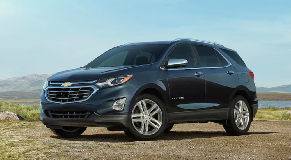 A black 2021 Chevy Equinox is parked on dirt under a blue sky after winning the 2021 Chevy Equinox vs 2021 Toyota RAV4 comparison.