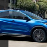 A blue 2021 Honda HR-V Sport is shown from the side driving through the city.