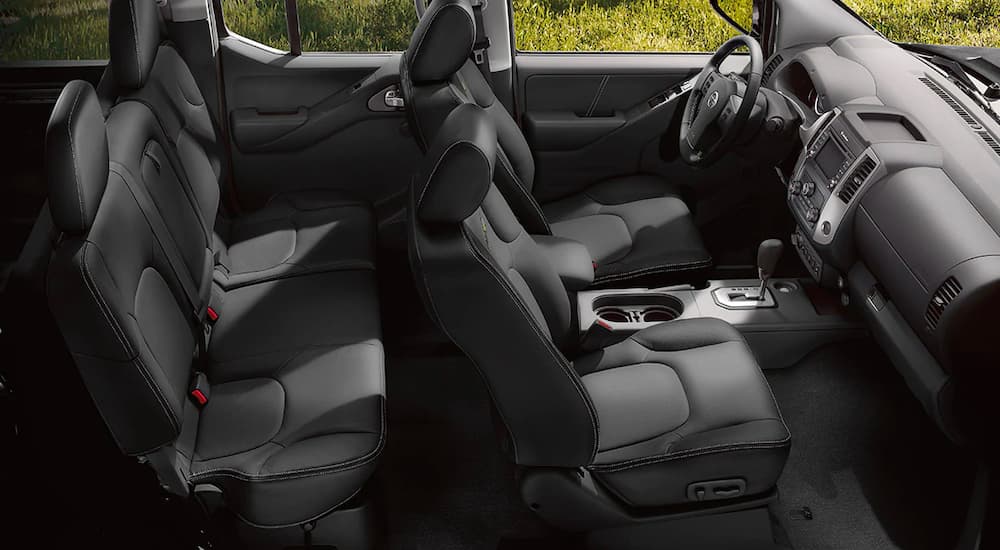 The black interior is shown from the passenger side in a 2021 Nissan Frontier Pro4x.