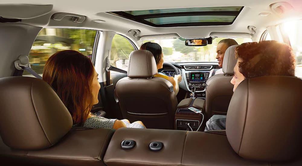A family is shown from behind in a 2021 Nissan Murano.
