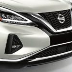 A close up shows the front end of a white 2021 Nissan Murano.