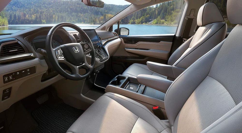 The gray and black steering wheel and interior are shown in a 2022 Honda Odyssey from the driver side.