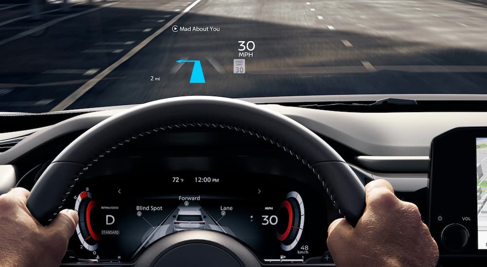 The steering wheel and Head Up display are shown in a 2022 Nissan Pathfinder.