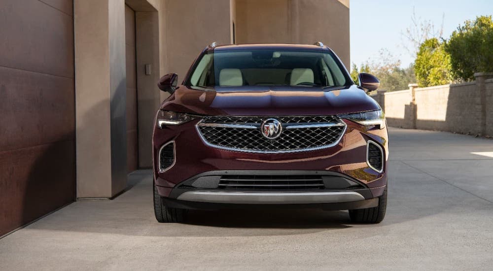 A burgundy 2021 Buick Envision Avenir is shown from the front.
